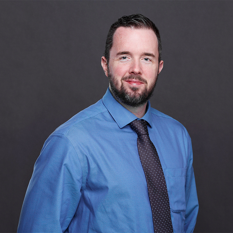 A headshot of Dr. Graham Carlos at Indiana University is shown.