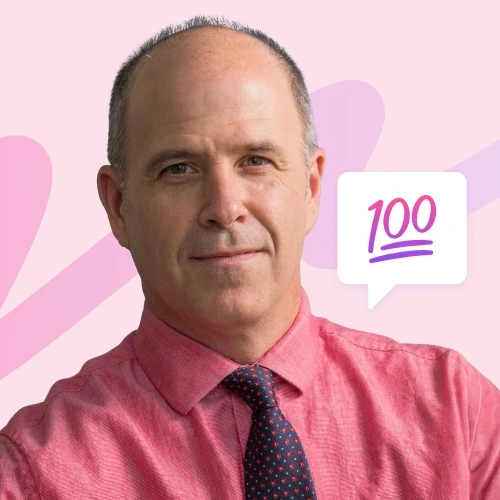 A balding man in a red shirt and patterned tie looks directly at the camera, with a pink background and a speech bubble containing '100' to his right.