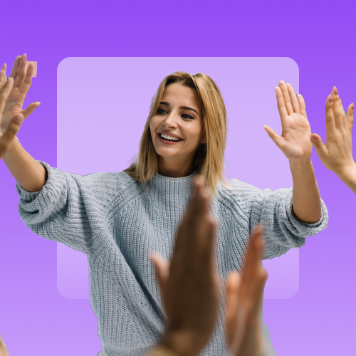 A smiling woman in a light blue sweater extends both hands forward, while other hands appear to be high-fiving her from the sides, all against a purple background.